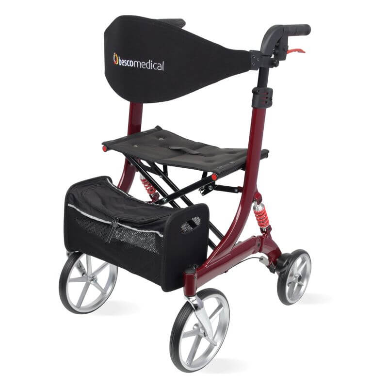 Spring  Rollator von Bescomedical, Front-/Seitenansicht eines Rollators in der Farbe bordeauxrot mit Rückengurt und Einkaufstasche